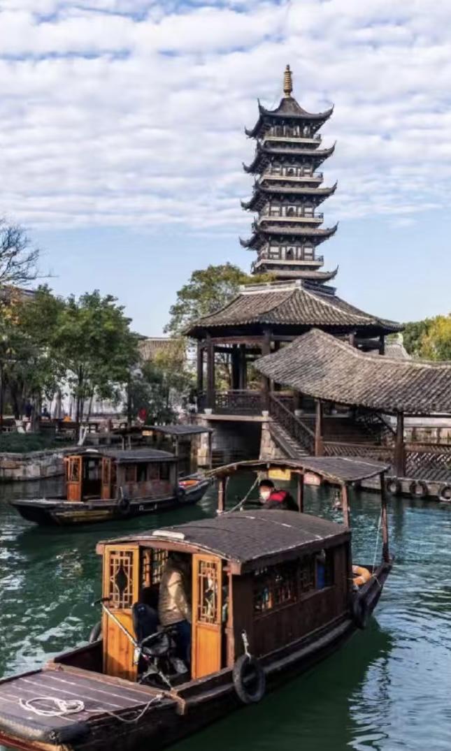 Jiangnan water town canal at dawn with a single wooden boat